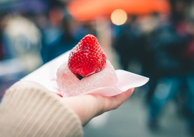 Hånd holder en jordbær-daifuku