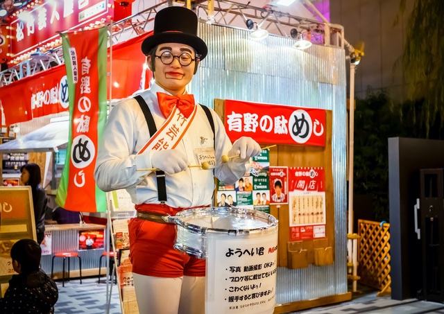 Entertainer optræder på Dotonbori Street, Osaka